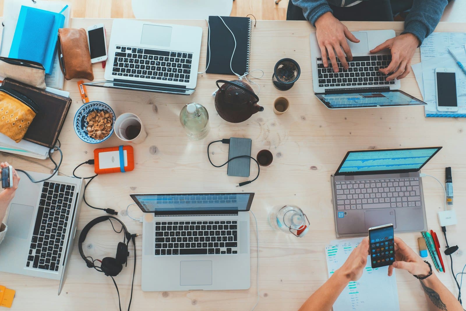 A team working across laptops and devices.